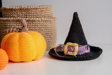 Decor With Your Own Hands For The Halloween Holiday Crocheted Orange Pumpkin, Witch Hat, Glasses, Jute Baskets On A White Background.