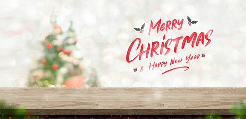 Leinwandbilder - Merry Christmas and happy new year text over wood table top at blur bokeh xmas tree decor with string light background,Winter  greetng card for winter seasonal