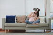 © interstid - beautiful excited Asian woman in VR headset feeling excited aand surprised in virtual reality at home