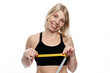 Smiling woman with a measuring tape on her chest. Pretty blonde in a sporty black top. Sports, diets and healthy lifestyles. Isolated on white background.