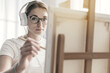 © StockPhotoPro - Young woman painting in the studio