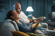 © StockPhotoPro - Happy couple watching TV together