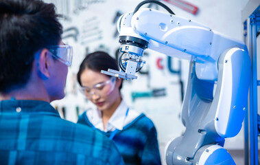 Wall Mural - Meeting asian Engineers Maintenance Robot Arm at Lab. they are in a High Tech Research Laboratory with Modern Equipment. Professional Japanese Development Engineer Testing an Artificial Intelligent.