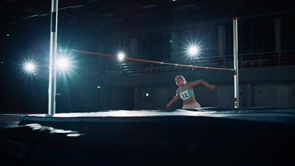 Wall Mural - High Jump Championship: Professional Female Athlete Running with Jumping over Bar. Determination, Endurance, Motivation, Effort of Champion in Training. Slow Motion Dramatic Light, Wide Dolly Shot