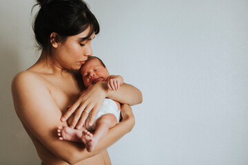 Wall Mural - mother holding her infant baby