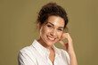 © deniskomarov - Happy young female brunette smiling wide on beige studio background with copyspace. Laughing girl with white teeth smile looking at camera. Positive human emotions, natural woman beauty.