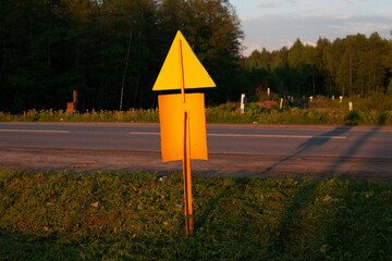A pillar with a sign. Triangle and rectangle on an iron stick. Place of designation of pipe laying. Gasification of Russia.