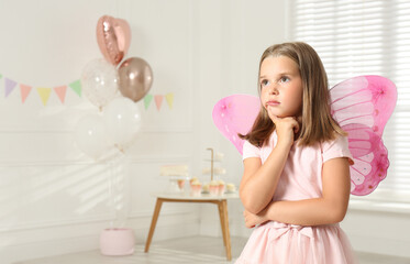 Poster - Cute little girl wearing fairy costume with wings in decorated room. Space for text