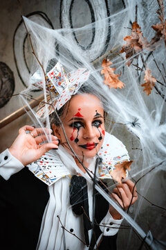 Portrait of young woman in Queen of Hearts costume with card collar