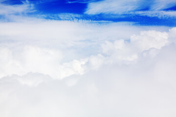 Wall Mural - White cumulus clouds blue sky background closeup beautiful aerial cloudscape backdrop, cloudy skies from above, sunny heaven fluffy cloud texture, airplane flight cloudiness landscape view, copy space