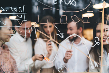 Wall Mural - Group of colleagues writing goals in office