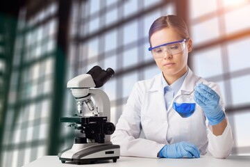 Canvas Print - Scientist woman doctor analyzing test results using medical microscope