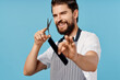© SHOTPRIME STUDIO - male hairdresser scissors comb blue background