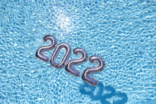 Silver Balloons With Numbers 2022 Lying On Water In Swimming Pool Closeup Background