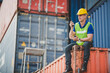 © chokniti - foreman or engineer are work in container shipping industry warehouse, logistic transport to import and export cargo at delivery storage port terminal, man are work to control a business box