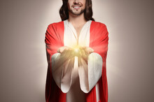 Jesus Christ On Beige Background, Closeup. Miraculous Light In Hands
