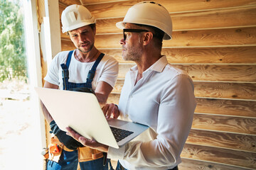 Wall Mural - Designing engineer and worker are using laptop