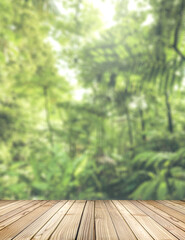 Empty rustic wood with jungle background blurred. Ready for put your product display and shelf montage concept with copy space. Wooden stage for objects presentation.
