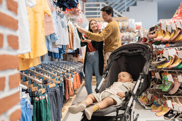 Canvas Print - asian mother with her toddler boy shopping in the baby shop