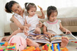 © DragonImages - Young mother and kids playing with toys and looking at photos in album when spensing day at home due to coronavirus pandemic