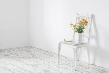 Wall Mural - bouquet of tansy on  old wooden chair in  white interior