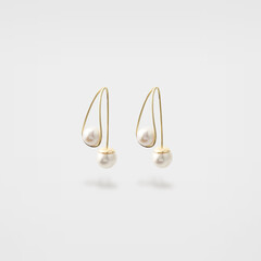 Silicon gold pearl earrings on gray background