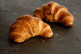 Fototapeta Na drzwi - Croissant with butter two pieces on a black board. High quality photo