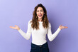 © luismolinero - Young caucasian woman isolated on purple background with shocked facial expression
