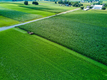 An Amish Farmer And His Four Horse Plow Team Plow A Corn Field Seen From An Aerial Drone