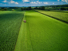 An Amish Farmer And His Four Horse Plow Team Plow A Corn Field Seen From An Aerial Drone