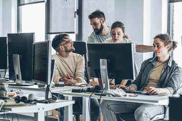 Group of programmers and software developers working on a new project at the office.	
