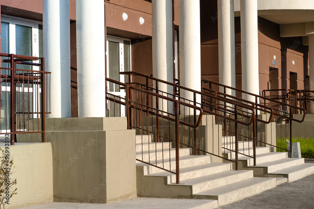 main entrance with stairs and railings of residential apartment ...