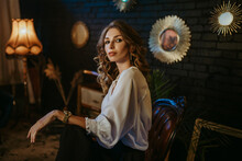 Young Beautiful Woman Wearing Elegant Vintage Outfit, Posing In Dark Interior. Copy, Empty Space For Text