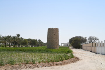 An old castle and an old stone building in the middle of the field