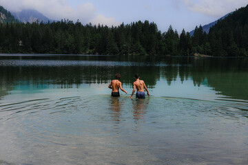 Two young males swimming in a river in summer