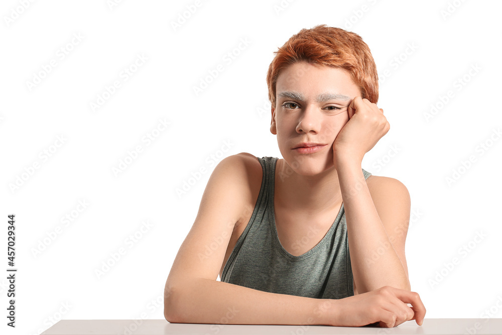 Teenage boy with dyed eyebrows on white background