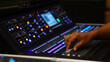 Male hand on audio mixer slider button. Focus selected on the slider button