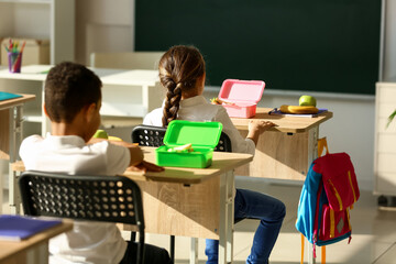 Poster - Cute little children having lunch at school