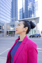 Thoughtful Businesswoman Looking Up In City