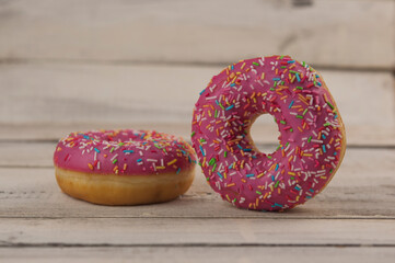 Poster - raspberry donuts on a wooden table