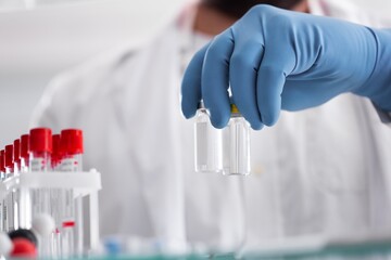 Poster - A covid-19 vaccine. Doctor's hand holds a bottle with a coronavirus vaccine