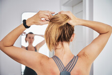 Woman Looking At Mirror After Fitness Exercise. Home Sport