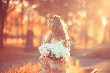 Wall Mural - happy girl with flowers in the city / summer photo young beautiful girl holding a bouquet of flowers