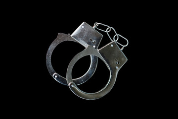 Leinwandbilder - handcuffs isolated on a black background