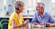 © Monkey Business - Retired Couple Sitting Around Table At Home Having Healthy Breakfast Together