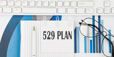 Poster - Office desk table with keyboard, chart,glasses and pen. Top view with text 529 PLAN
