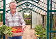 © Monkey Business - Portrait Of Senior Man Holding Box Of Home Grown Vegetables In Greenhouse
