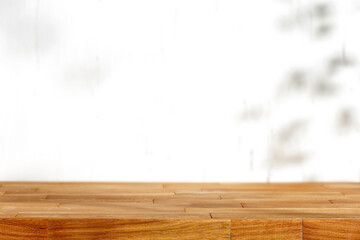 Wall Mural - wooden table with blank and white wall with sun shadows