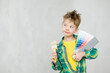 © Ermolaev Alexandr - Dreaming young Boy with color samples and paintbrush chooses the color of the walls of his room