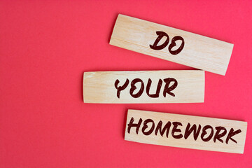 Do Your Homework Text on Wooden Blocks on red Background